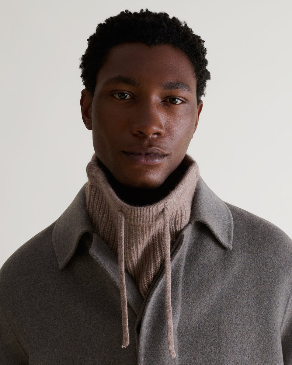 Man wearing toast cashmere merino drawstring snood with grey wool coat