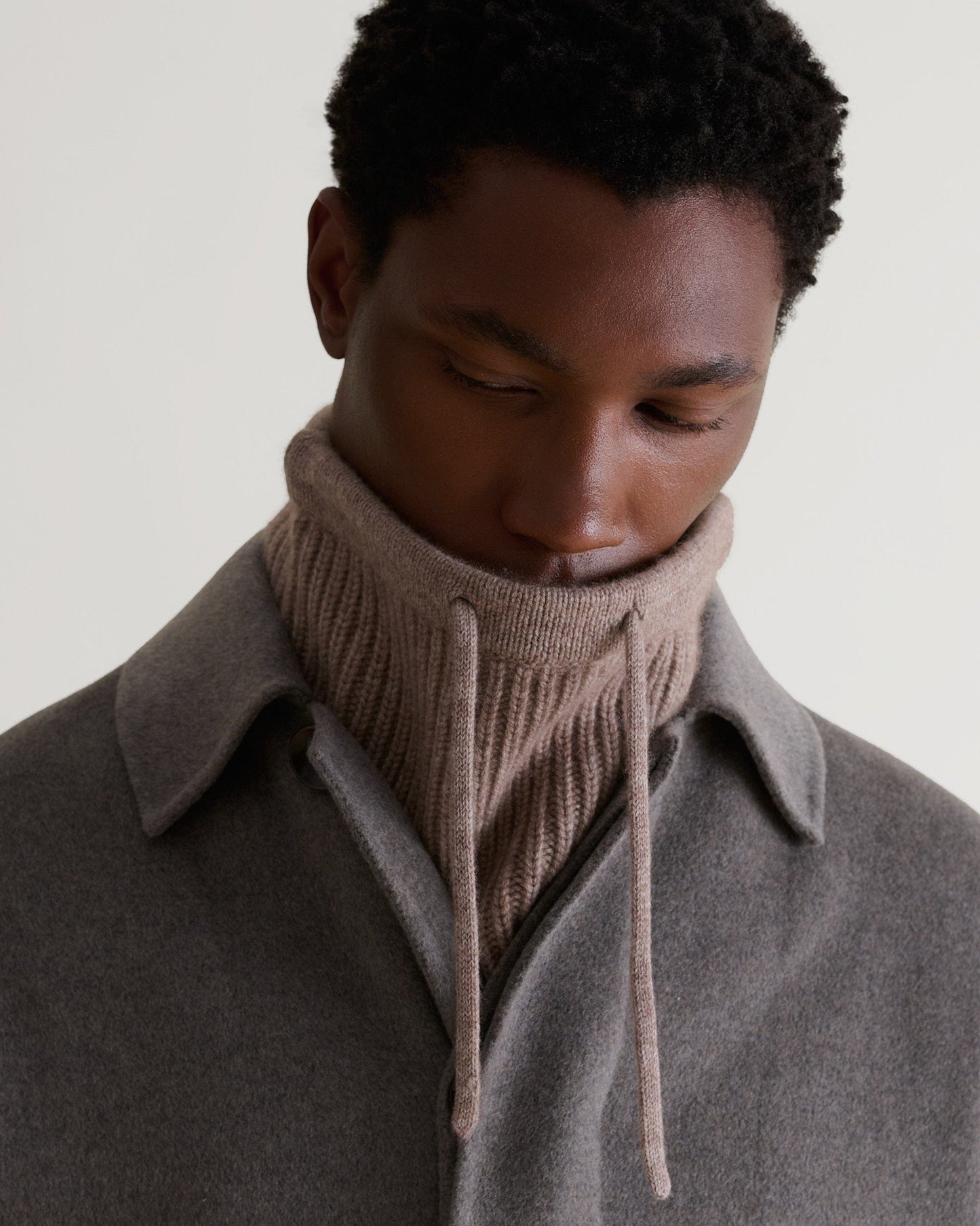Man's face tucked into toast cashmere merino drawstring snood