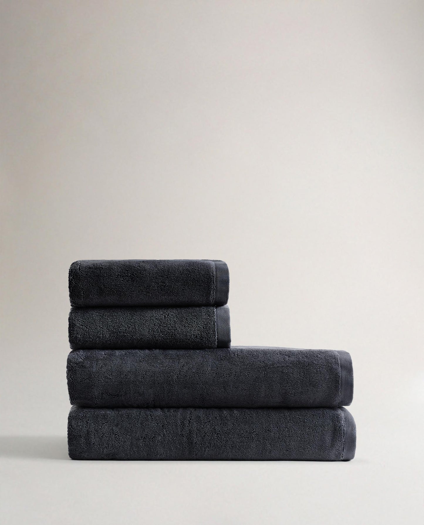 Side view of Rise & Fall's charcoal Turkish Aegea bath sheet bundle