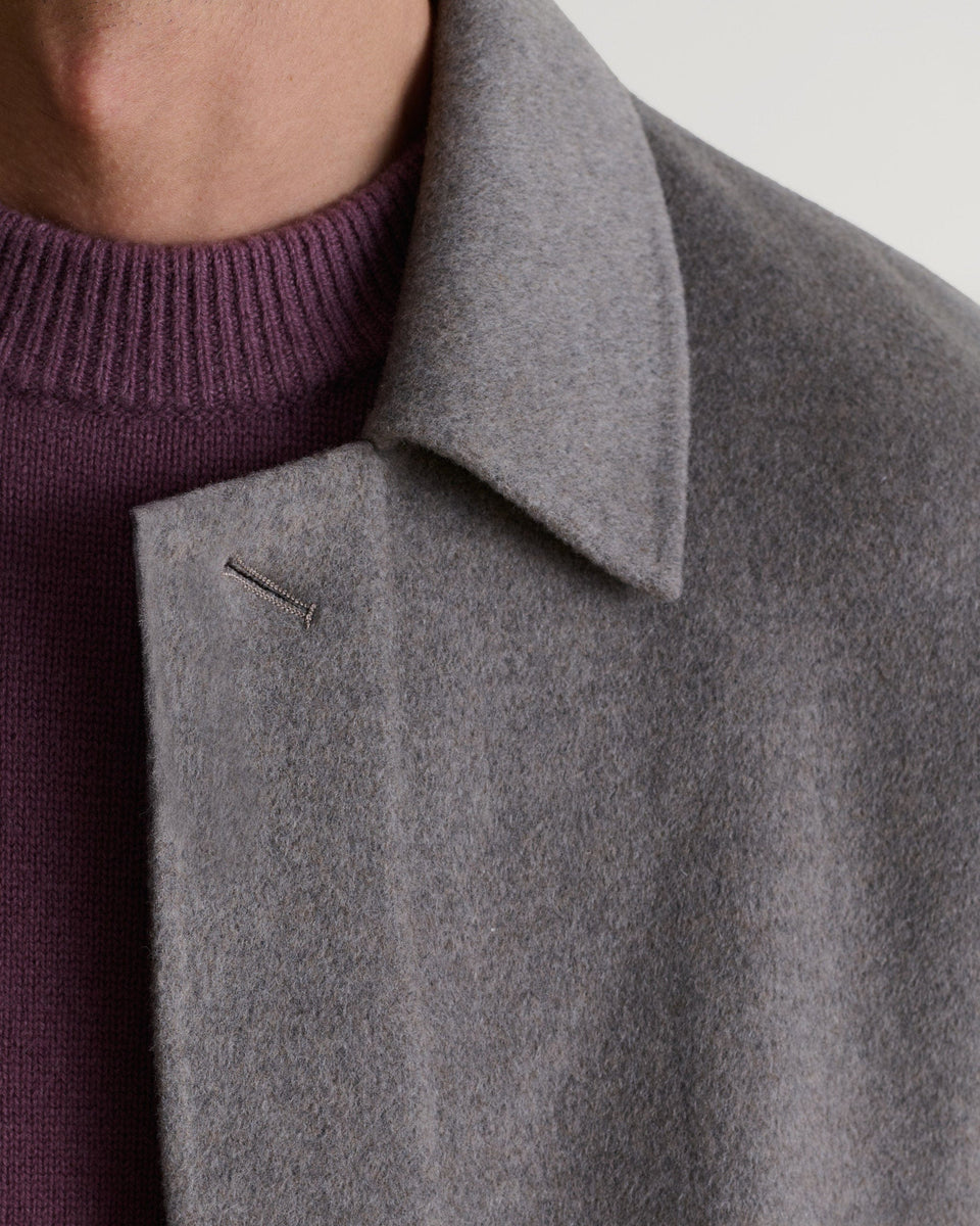 Rise & Fall's fawn coloured cashmere merino double-faced wool coat. Matched with burgundy jumper. Close up of neckline.