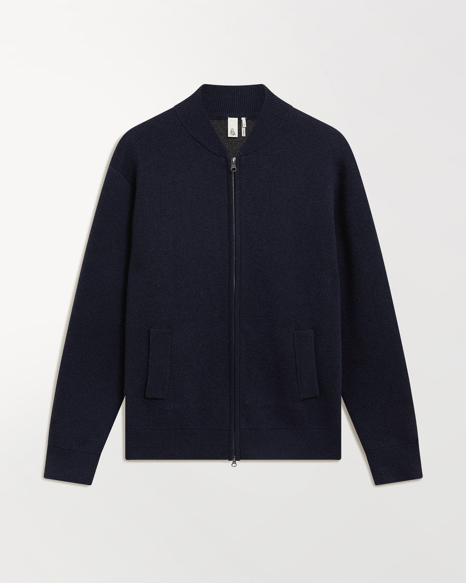 Close up of Rise & Fall's navy cashmere merino double faced bomber jacket.