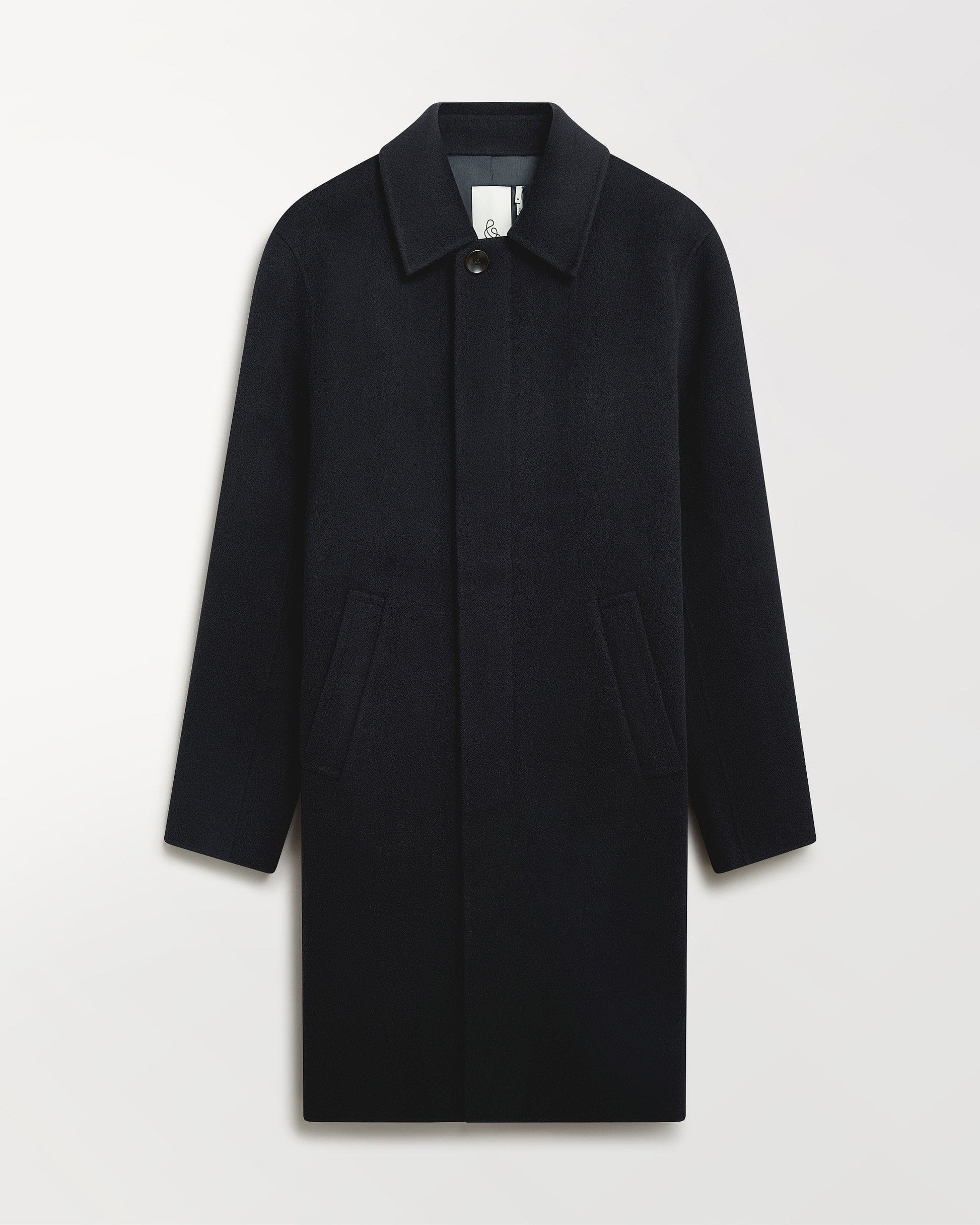 Close up of Rise & Fall's navy cashmere merino double-faced wool coat.