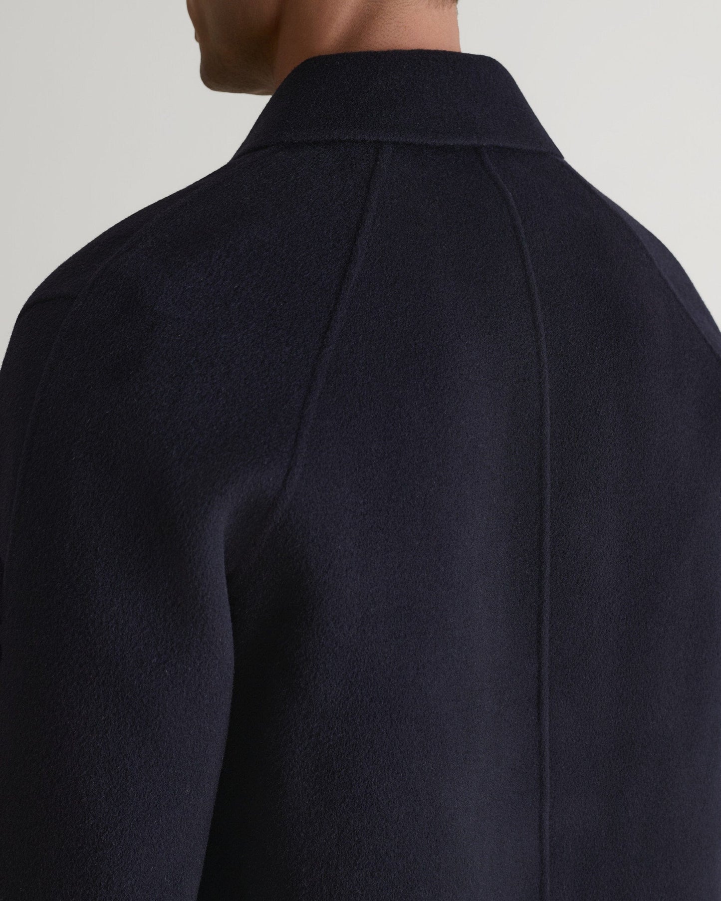 Rise & Fall's navy cashmere merino wool double-faced coat. Close up of back neckline.