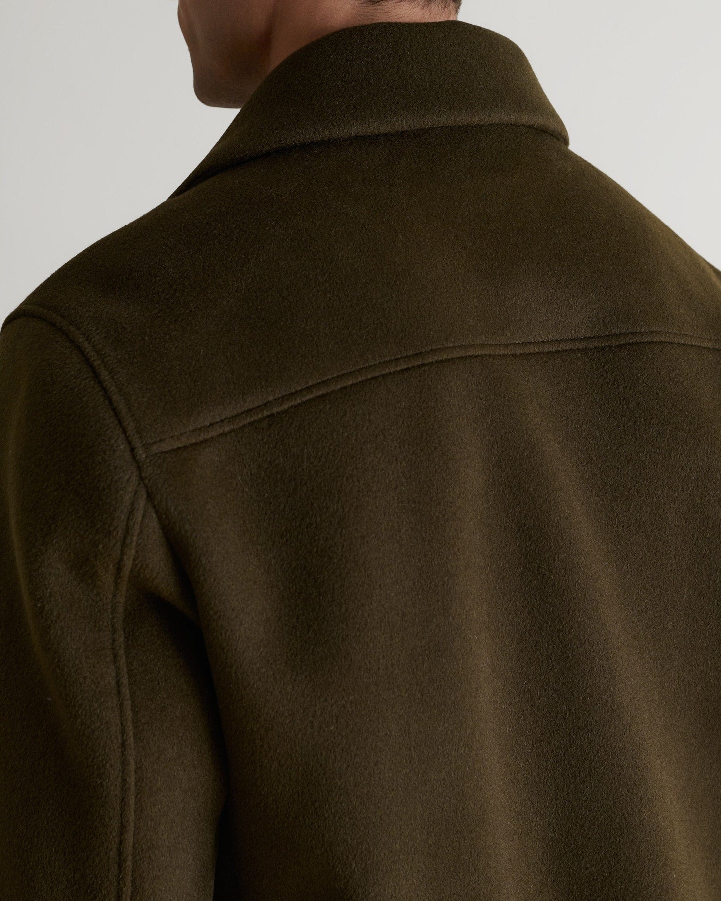 Close up of Rise & Fall's olive wool bomber jacket with shearling collar.