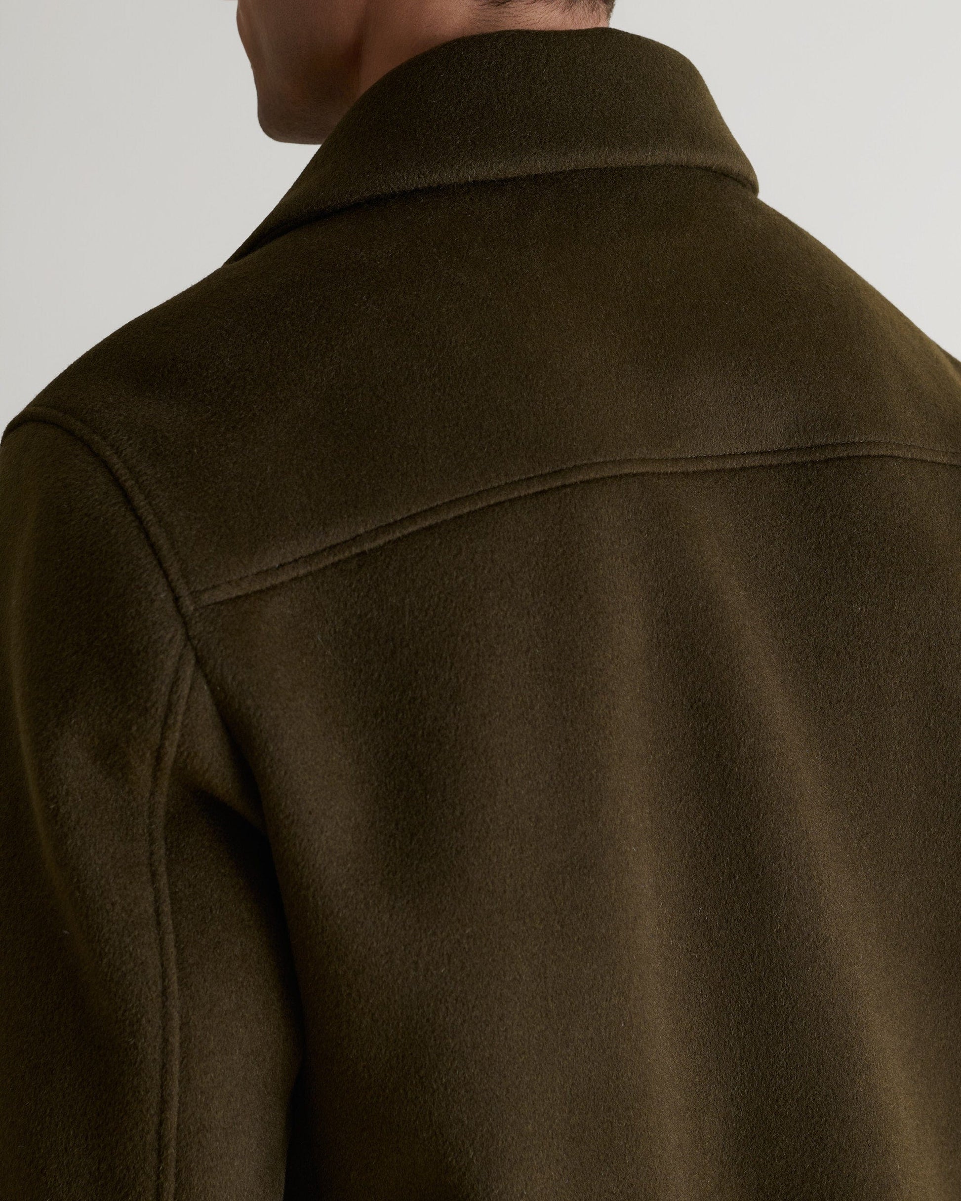Close up of Rise & Fall's olive wool bomber jacket with shearling collar.