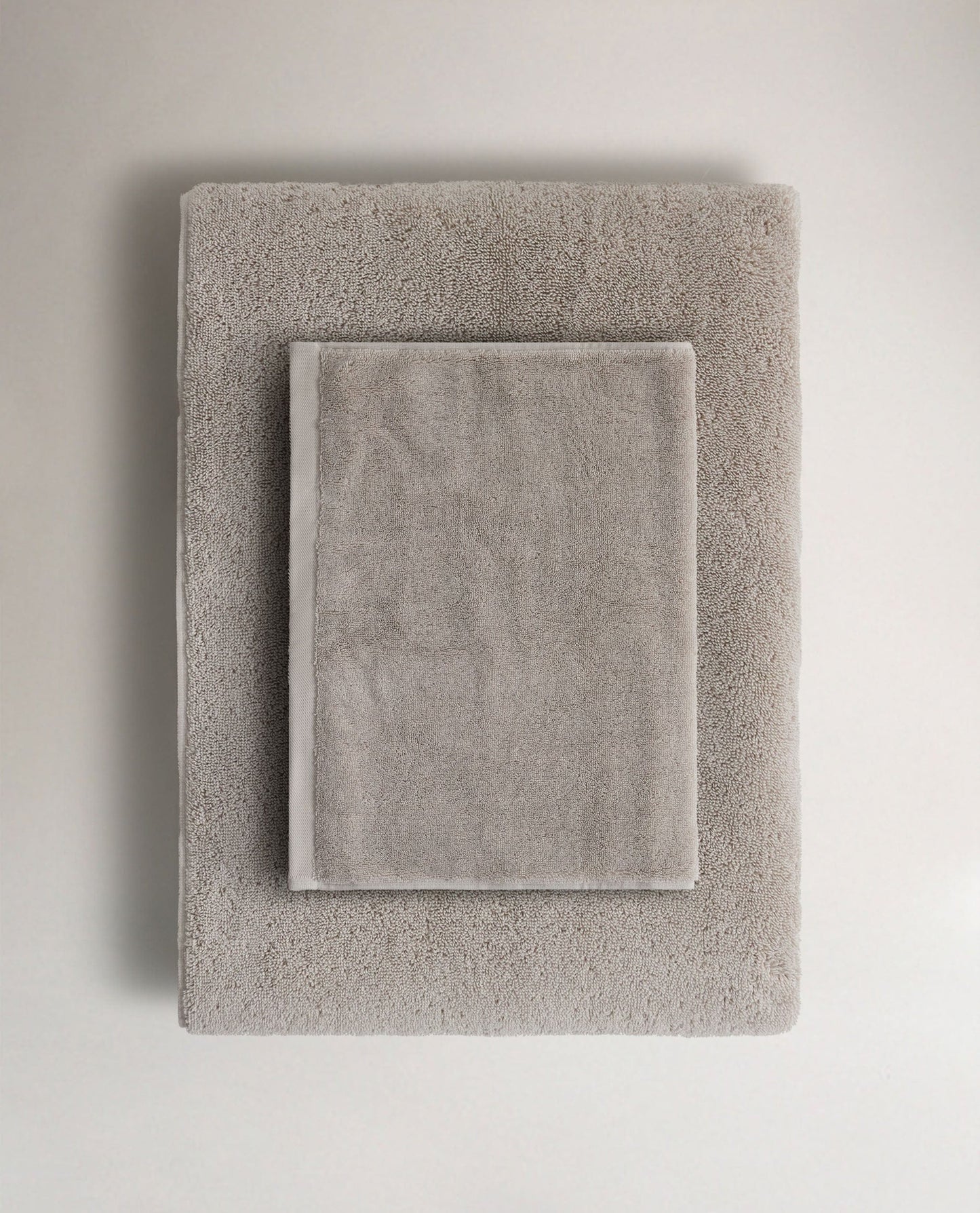 Rise & Fall's pebble Turkish cotton hand towel lying on top of matching bath towel