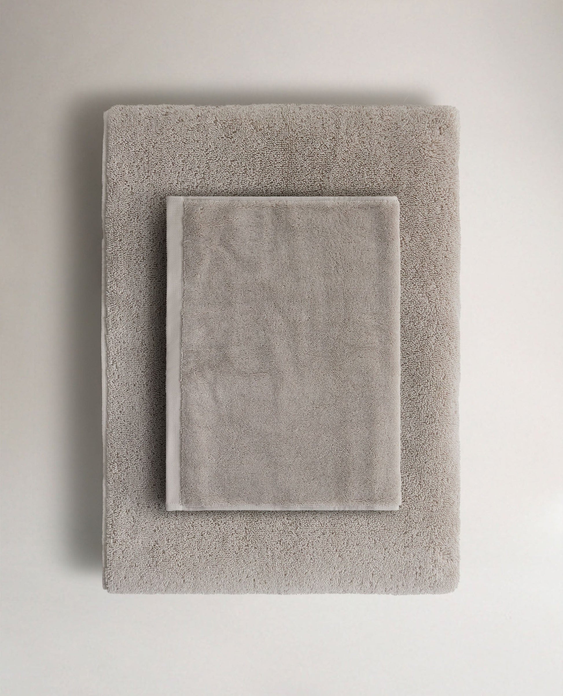 Rise & Fall's pebble Turkish cotton hand towel lying on top of matching bath towel