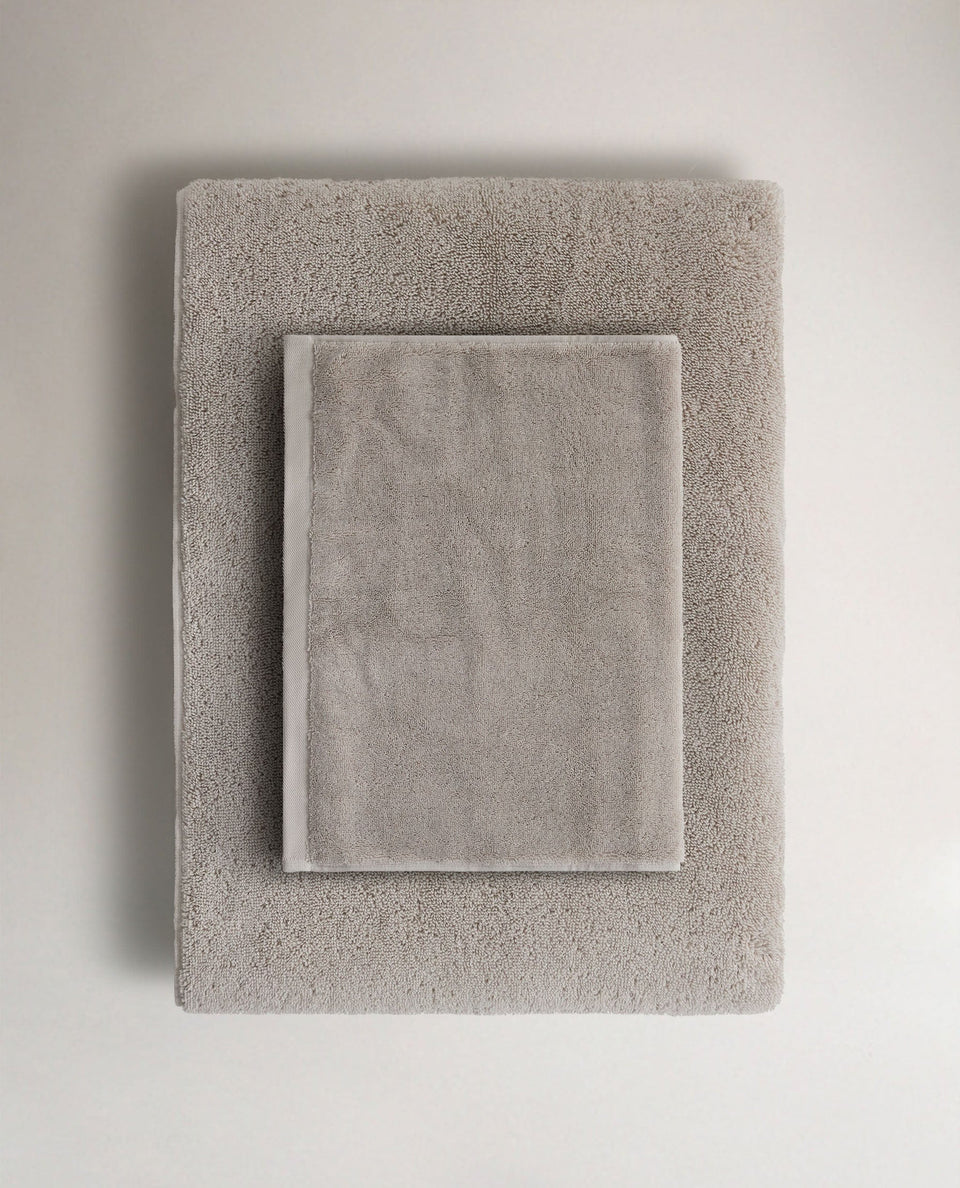 Rise & Fall's pebble Turkish cotton hand towel lying on top of matching bath towel
