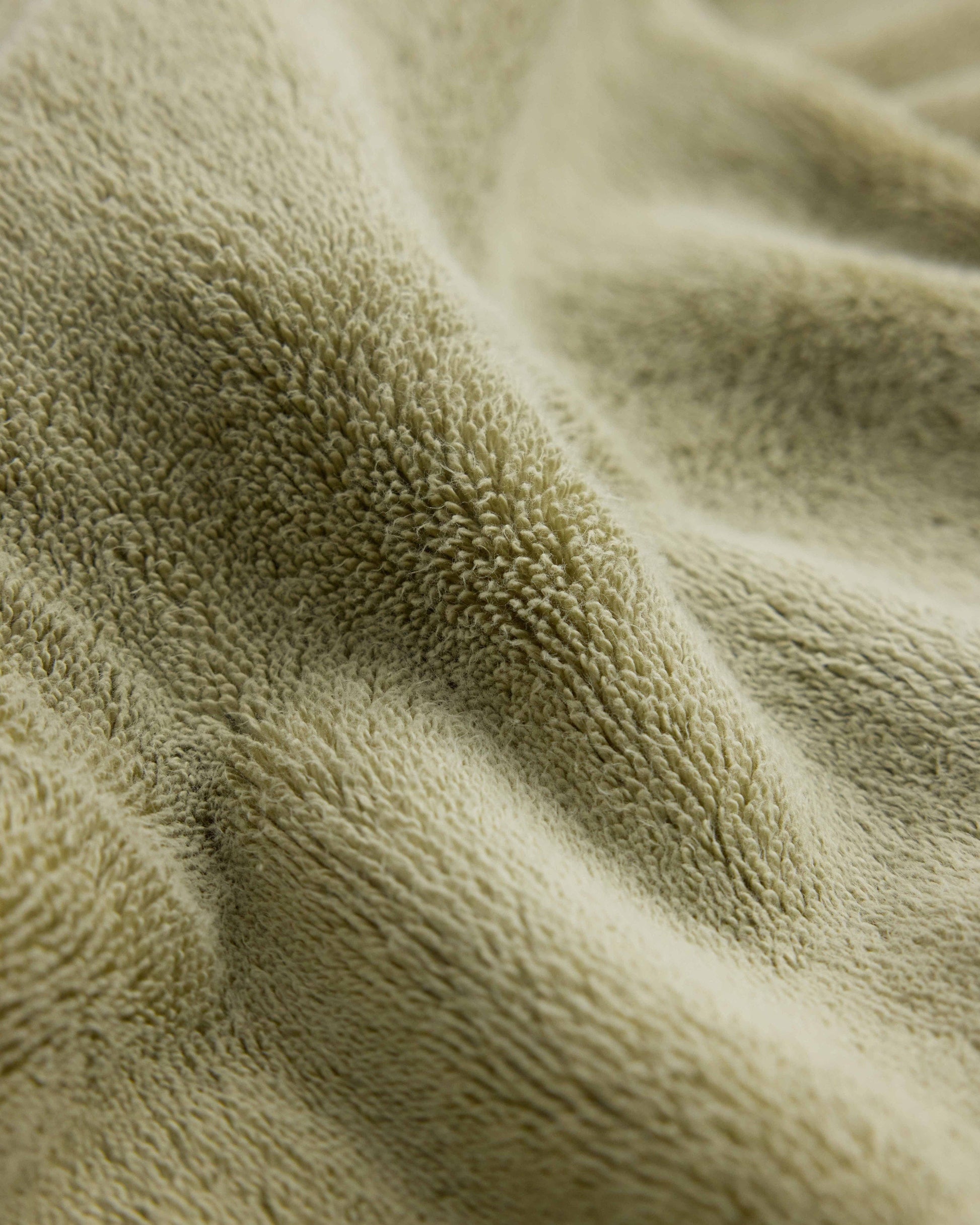 Close up of Rise & Fall's sage Turkish Aegean cotton towel