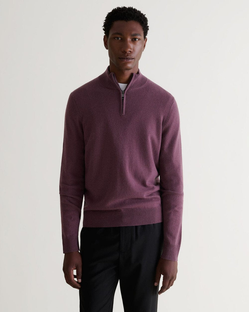 Front view of man wearing Rise & Fall's smoky lilac finest cashmere 1/4 zip jumper. Worn with black trousers and a T-shirt.