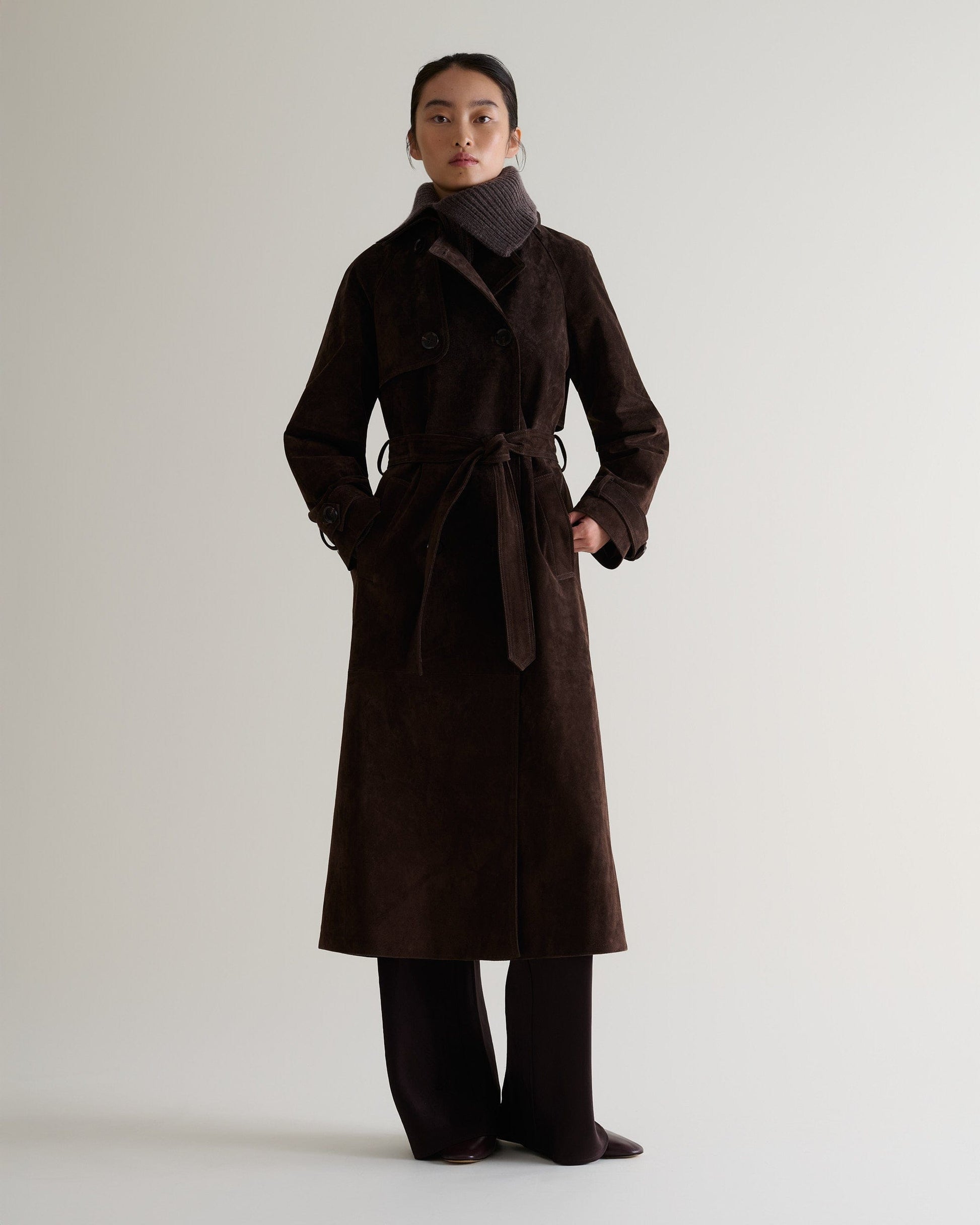 Full portrait view of woman wearing chocolate cashmere merino ribbed collar with chocolate suede coat